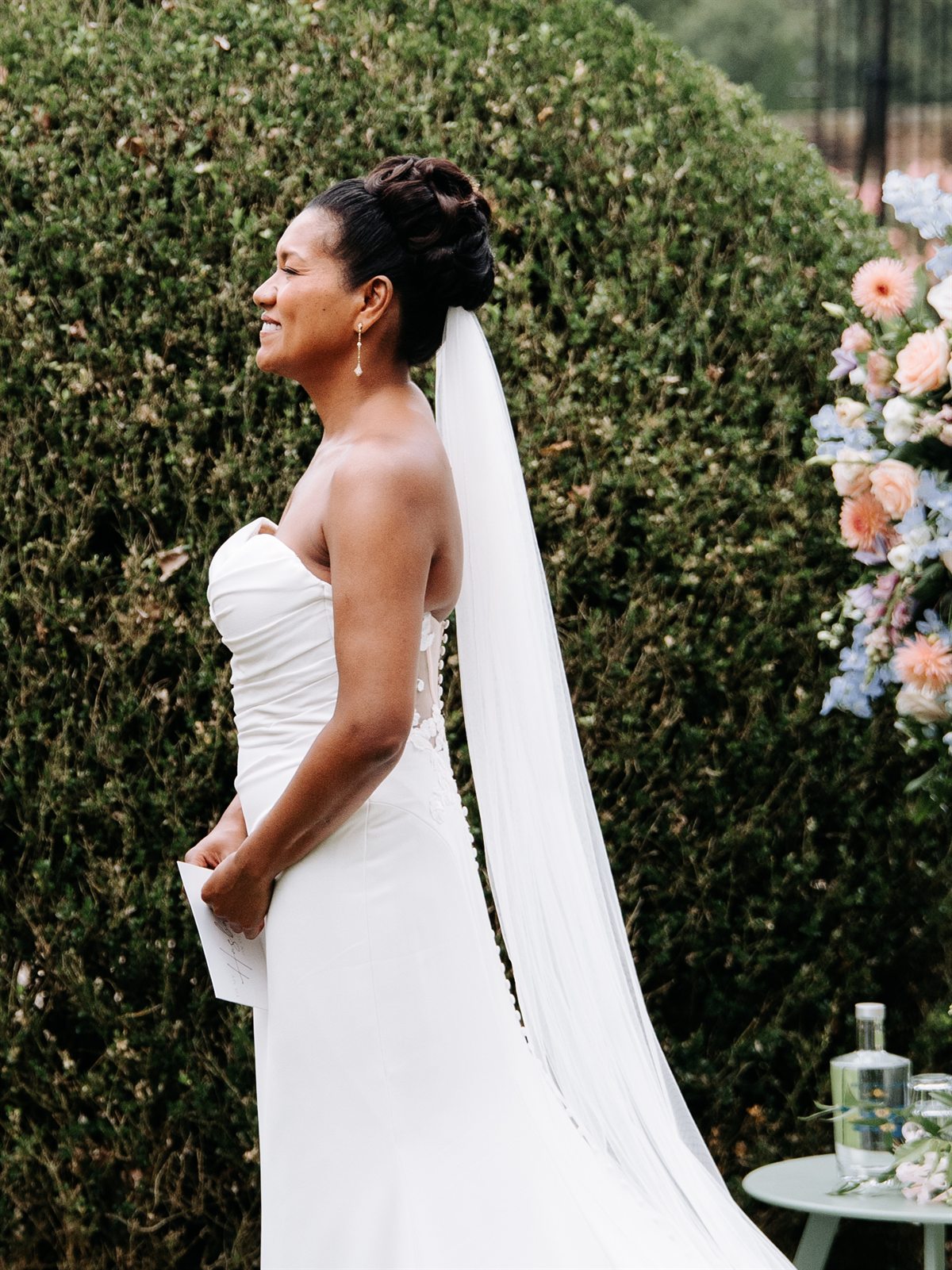 Bride with an updo and a long veil during the ceremony