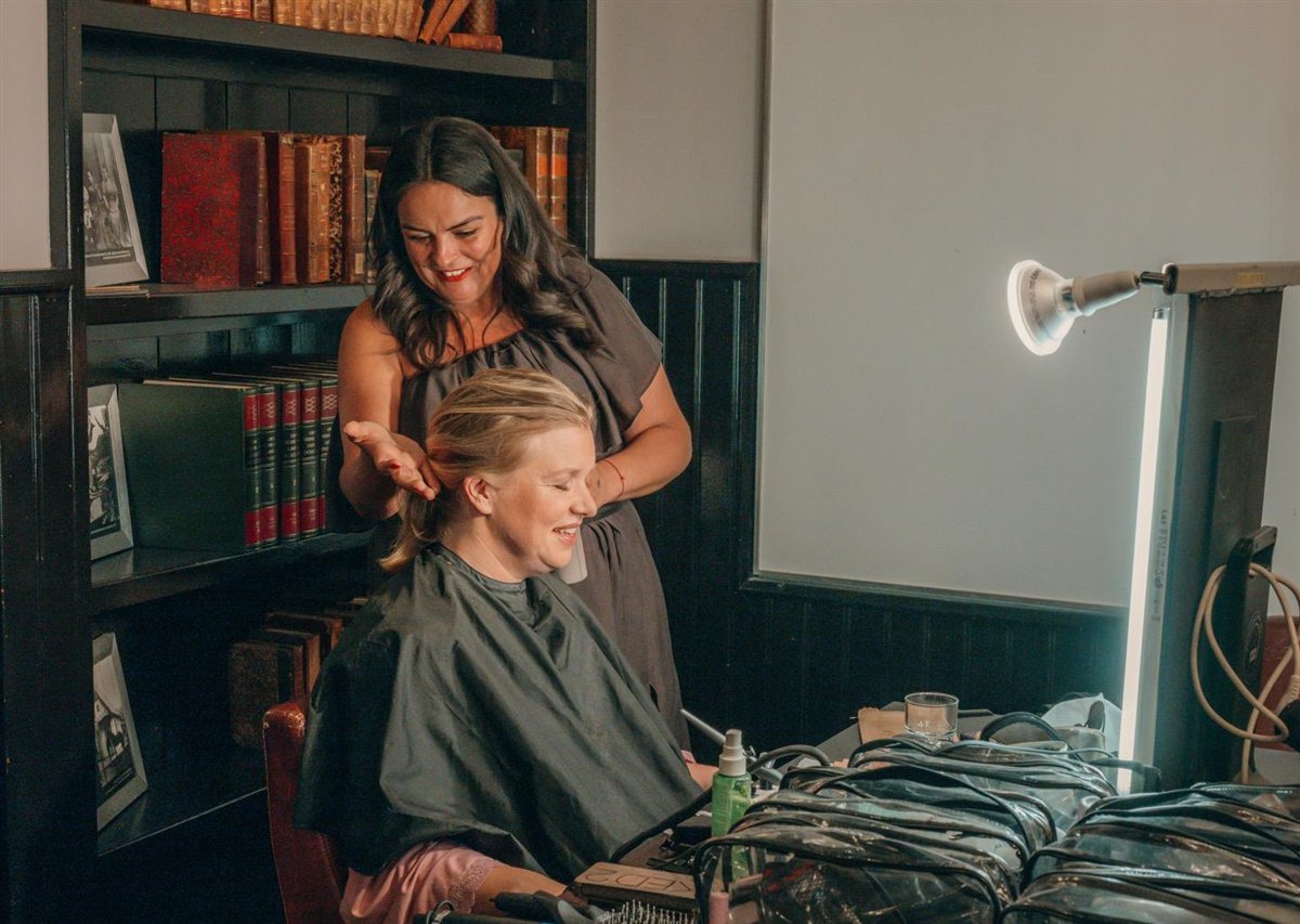 Nadia styling the bride's hair on location