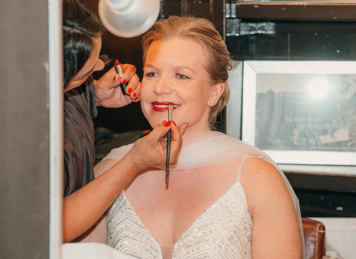 Nadia finishing the bride's lips